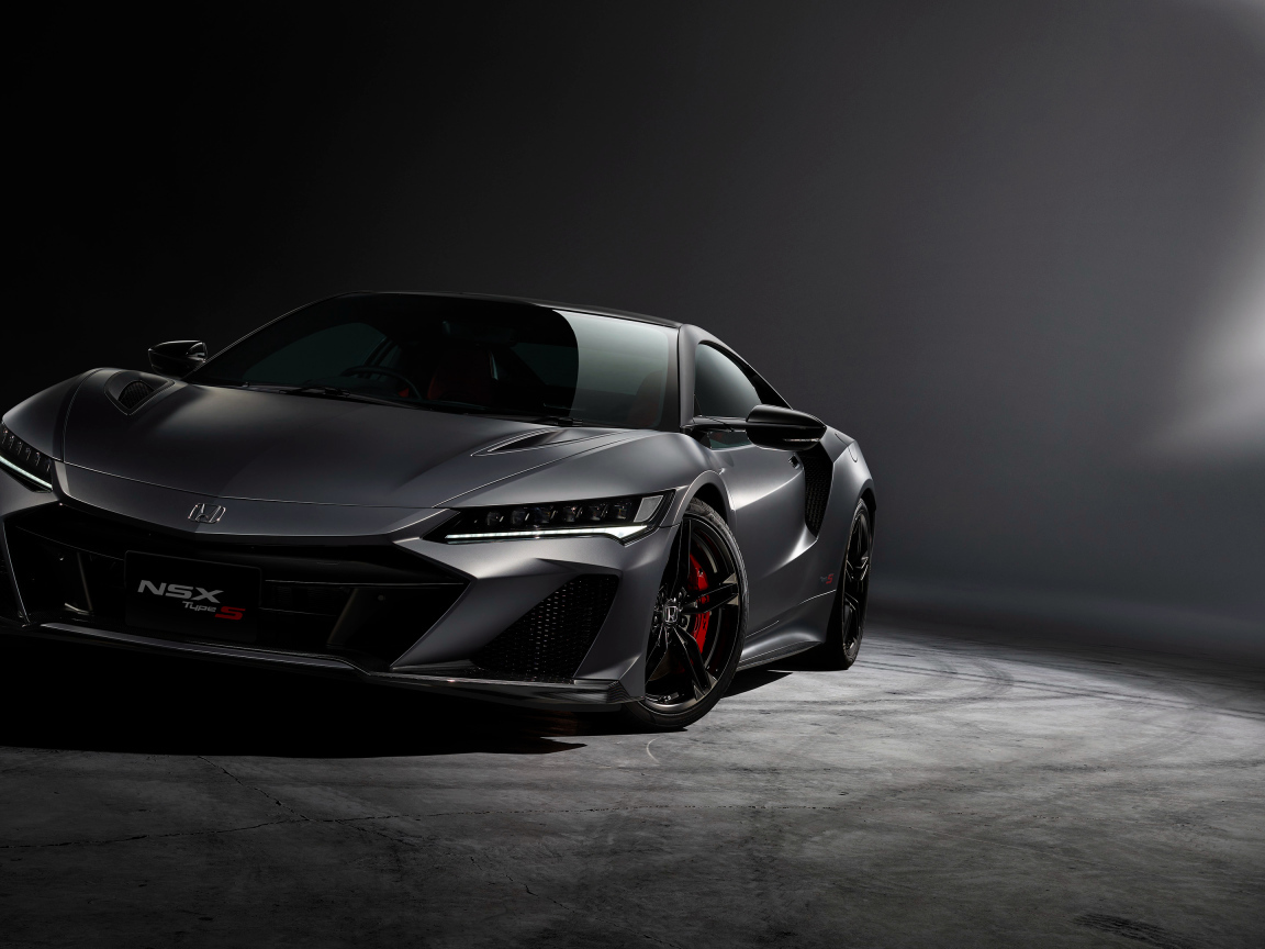 Серый быстрый автомобиль Honda NSX на сером фоне 