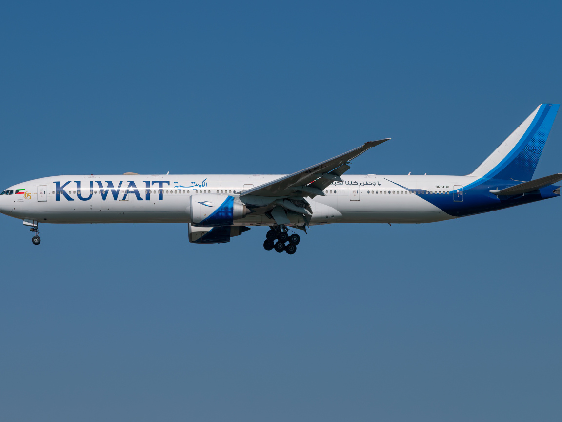 Kuwait 777-300ER airplane in blue sky
