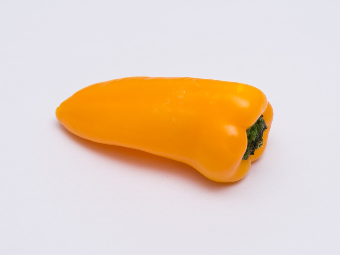 Желтый болгарский перец на сером фоне