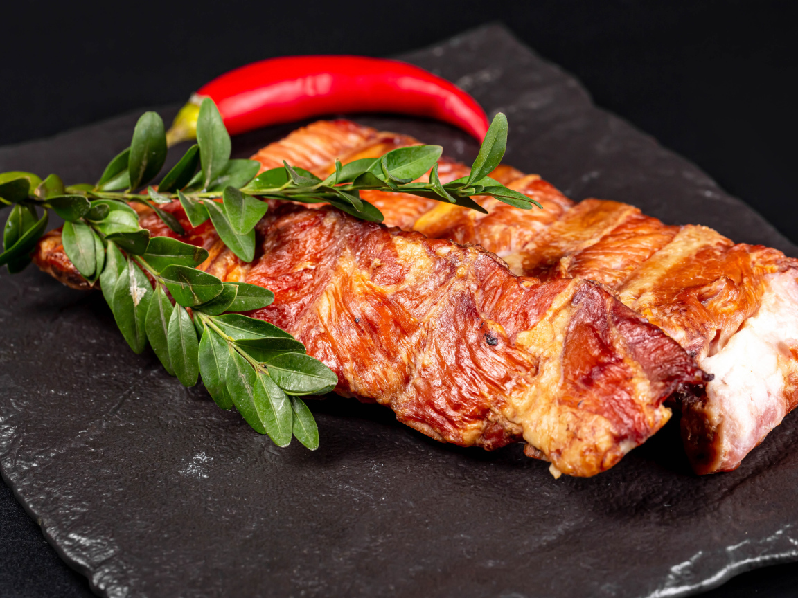 Копченые свиные ребрышки с зелеными листьями