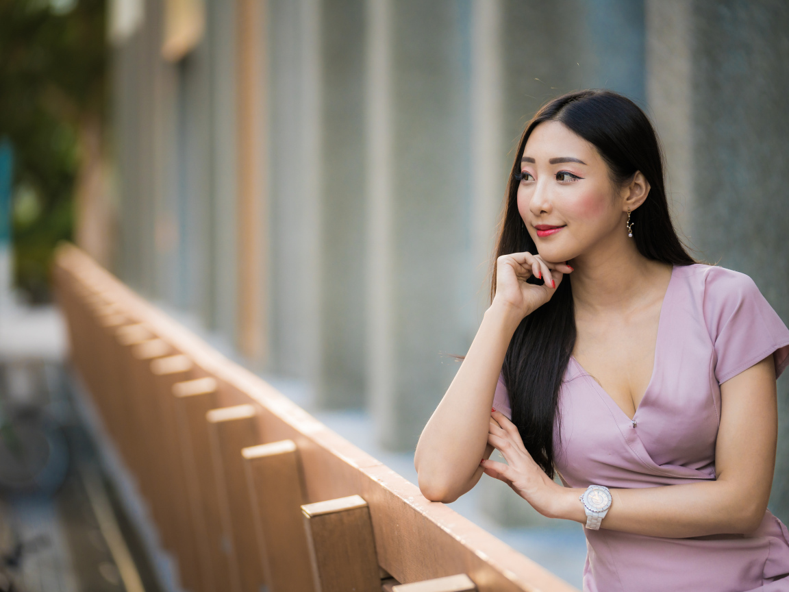 Красива девушка азиатка задумчиво смотрит вдаль