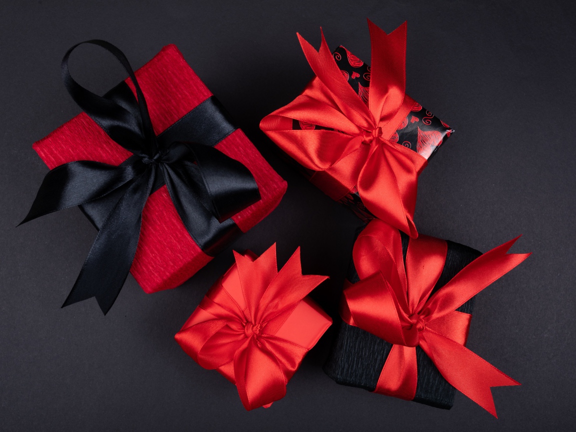 Bright boxes with gifts on a black background