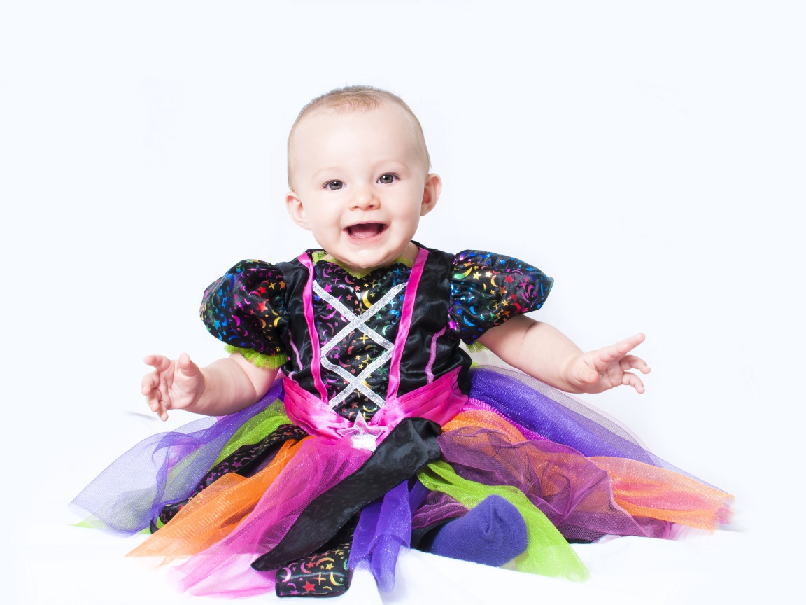 Маленькая улыбающаяся девочка на белом фоне 