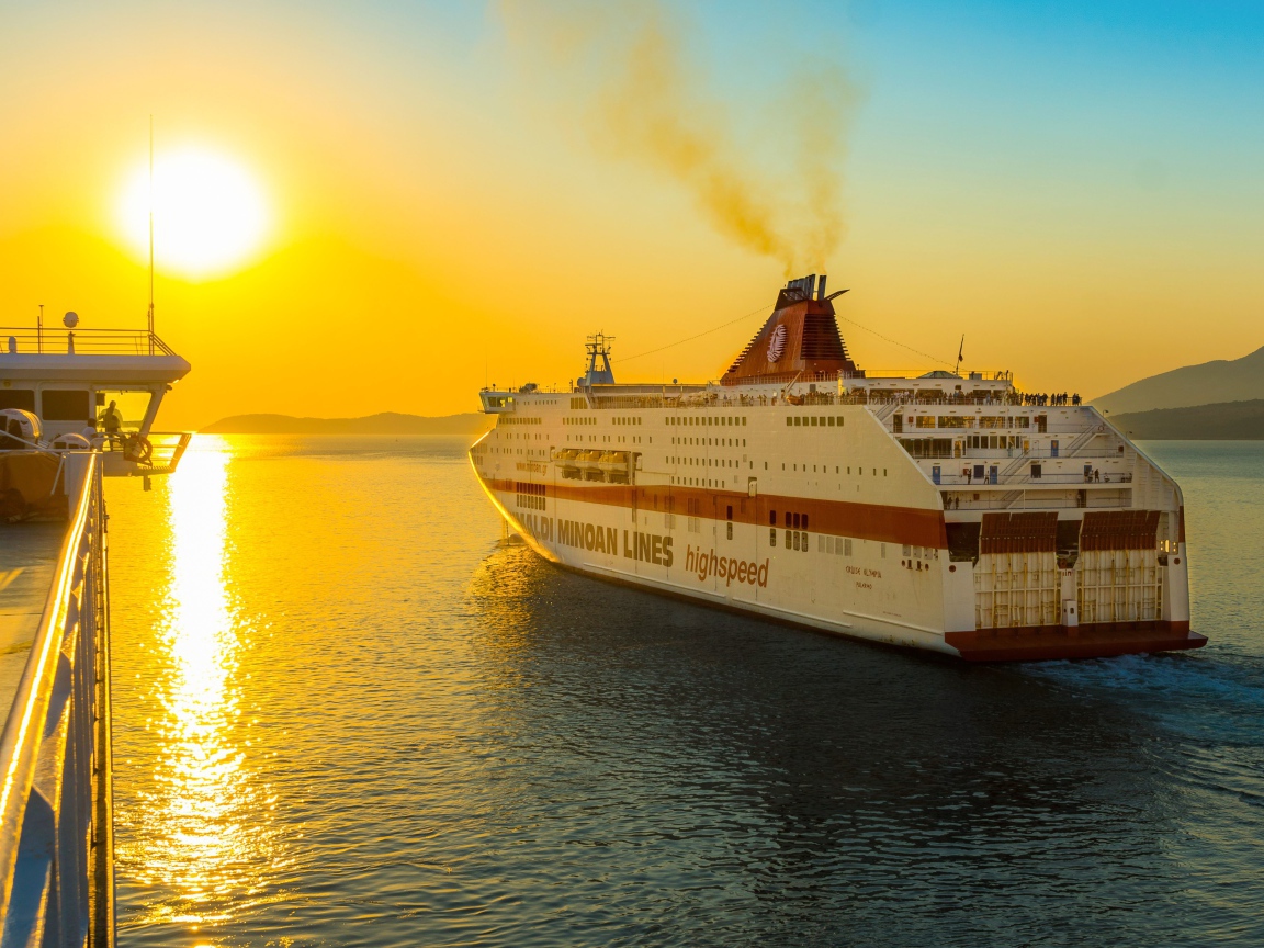 Large cruise ship sailing into the sunset