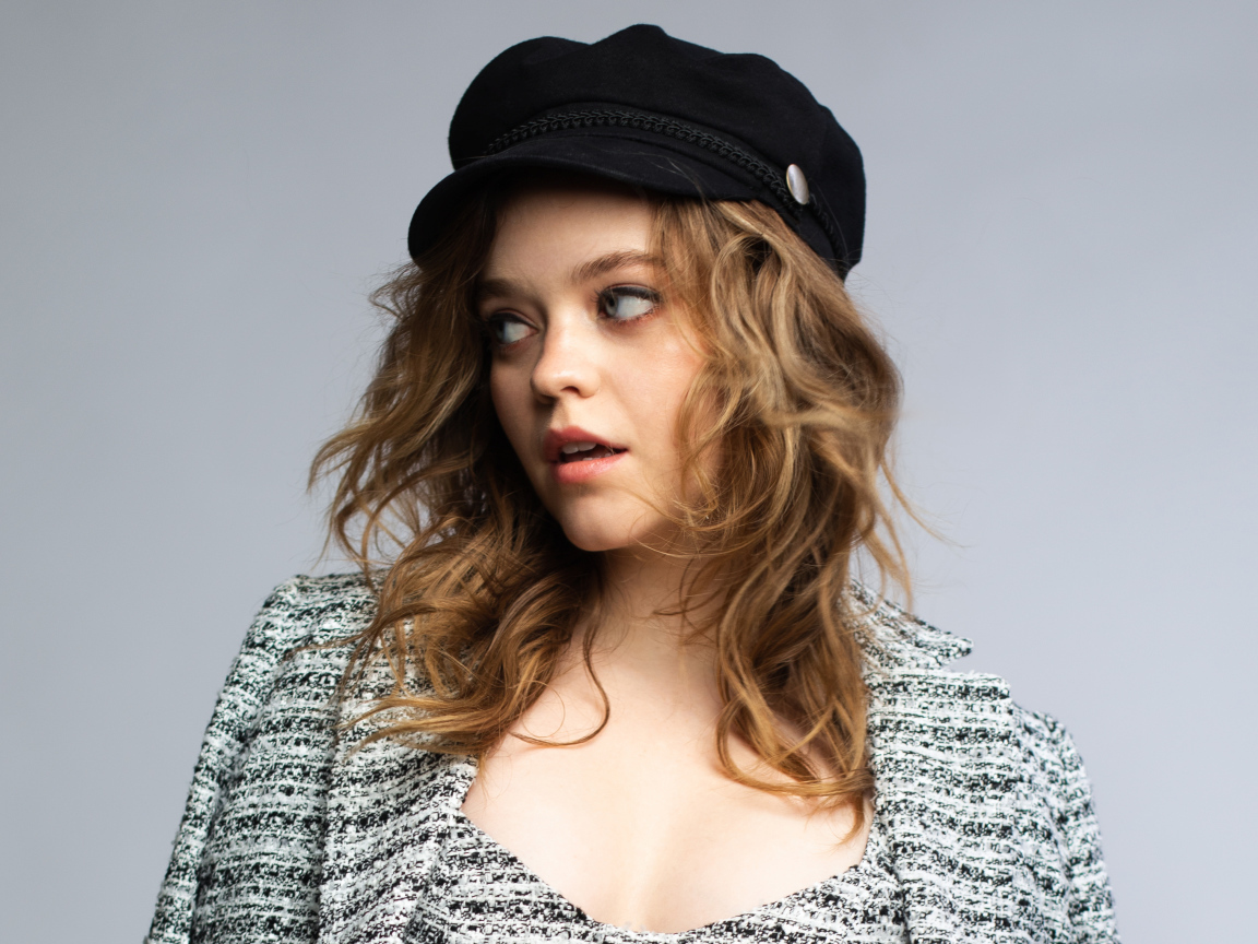 Актриса Джэйд Петтиджон смотрит в сторону на сером фоне