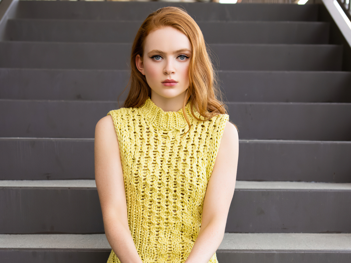 Red-haired girl actress Sadie Sink on the steps