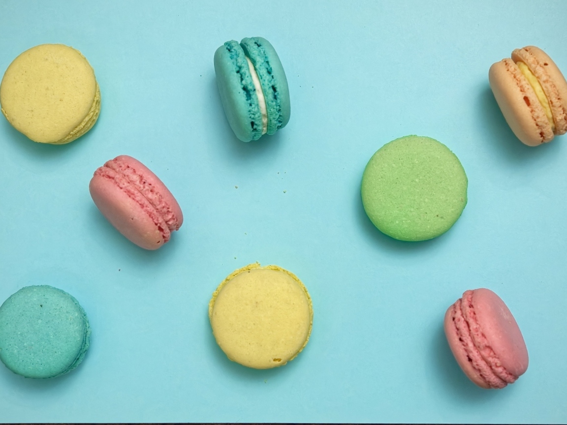 Разноцветный десерт макарон на голубом фоне