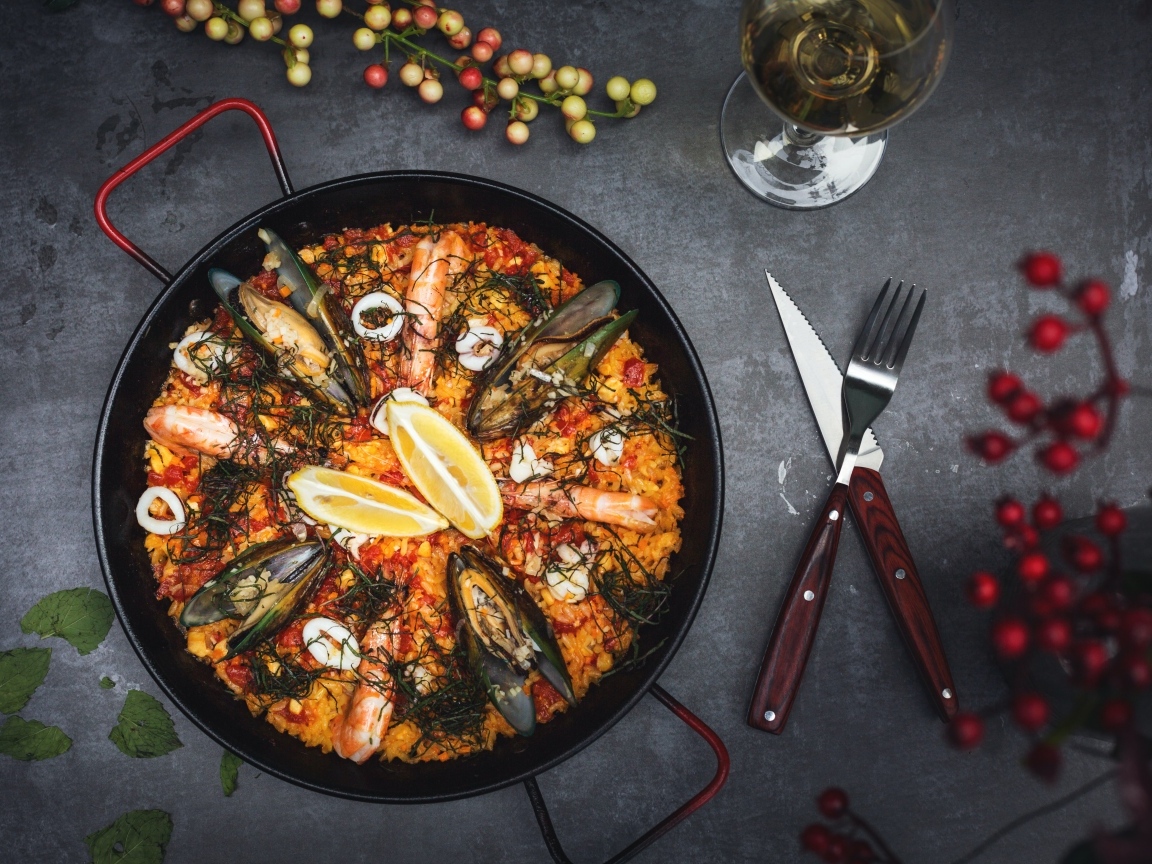 Блюдо из морепродуктов в сковороде на столе