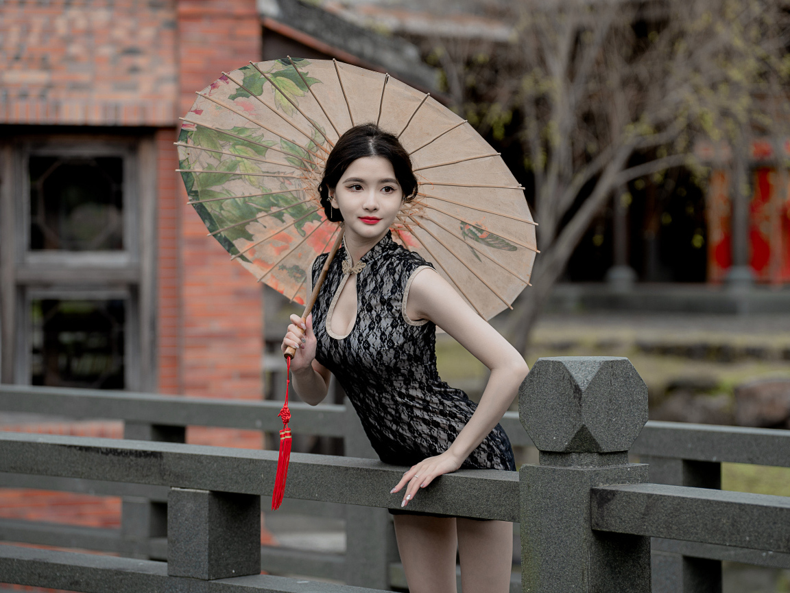 Симпатичная девушка азиатка с зонтом в руках