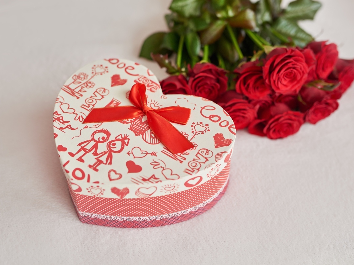 A heart-shaped box and a bouquet of roses for a girl on February 14
