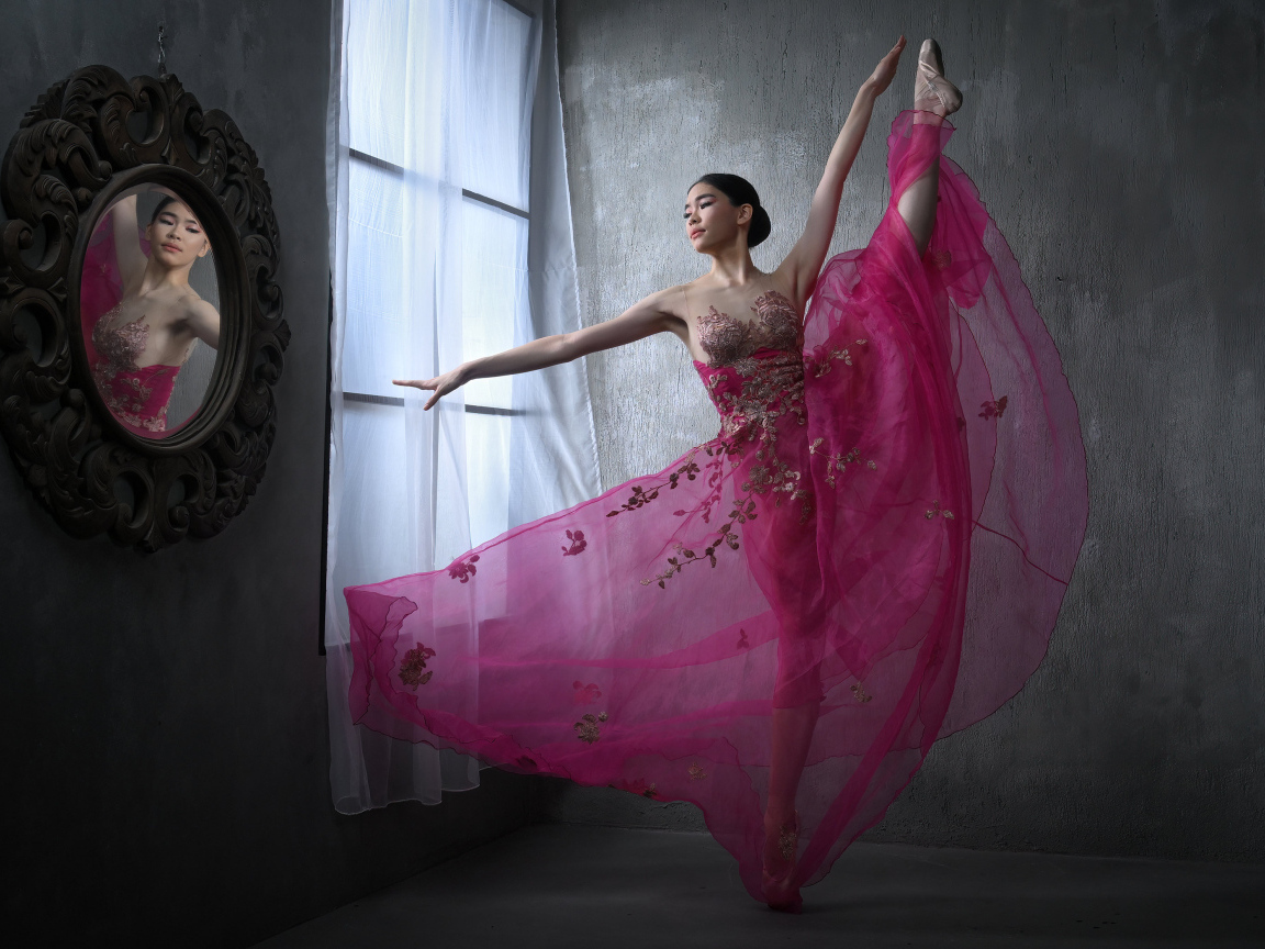 Девушка балерина в красивом розовом платье у окна