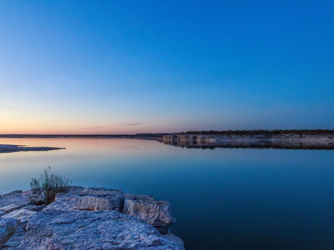 Голубое небо над водой на рассвете