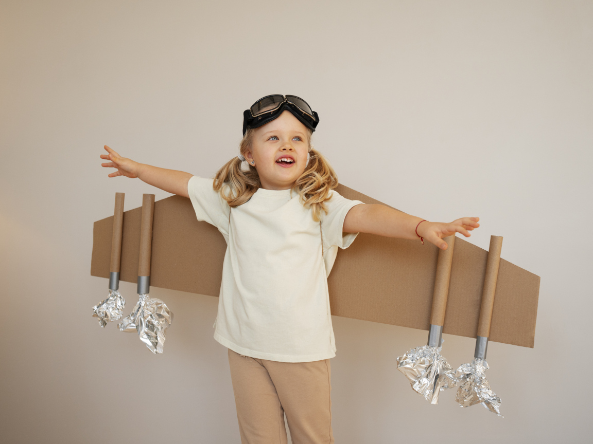 Маленькая девочка с крыльями из картона