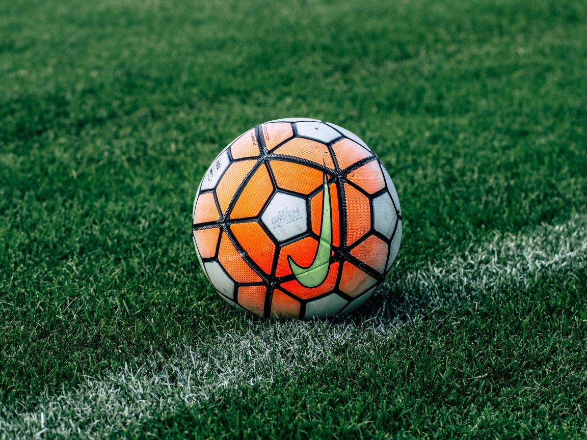 Футбольный мяч на зеленом поле