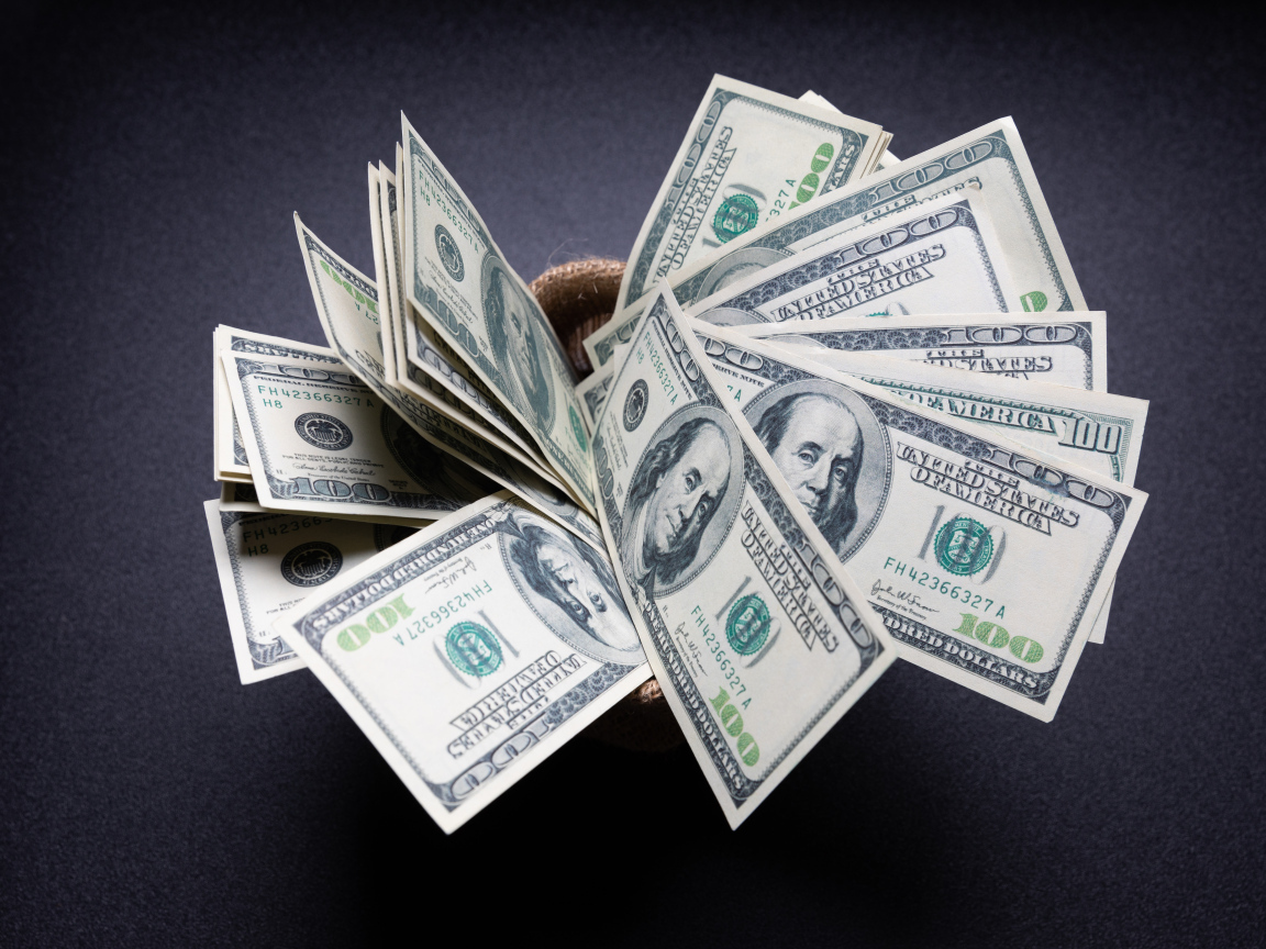 Пачка долларов на сером фоне