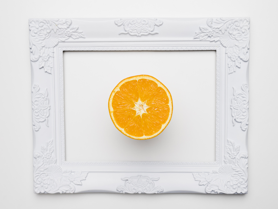 Белая рамка для фото с половиной апельсина