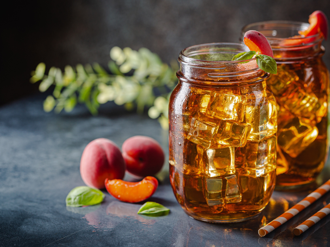 Холодный чай со льдом на столе с абрикосами