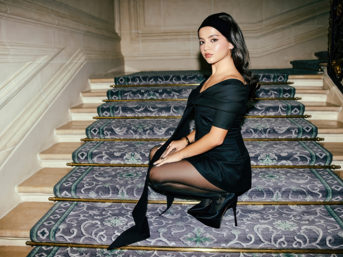 Actress Isabela Merced in a black dress on the steps