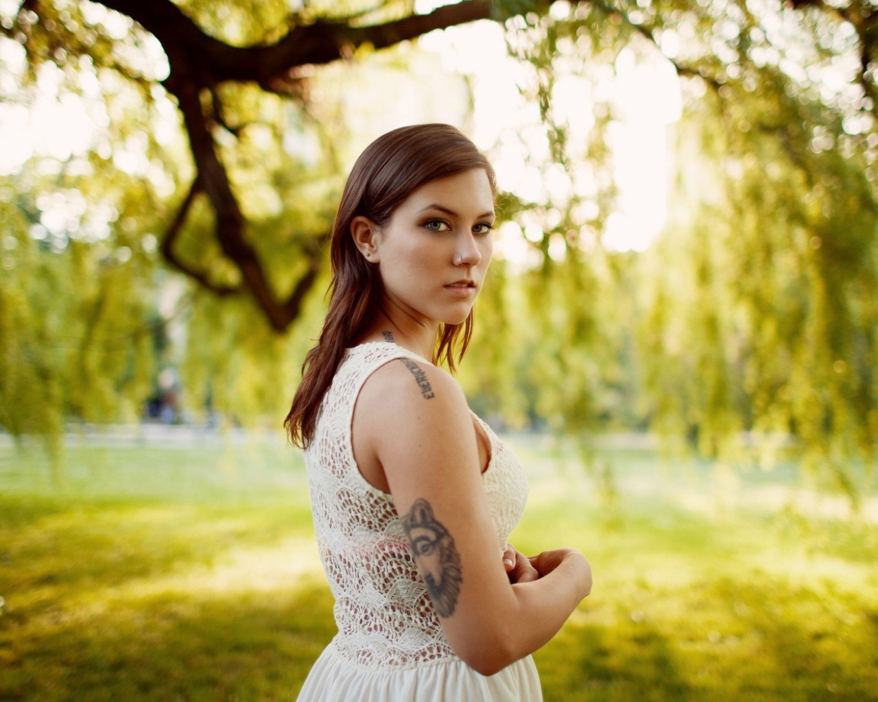 Брюнетка с татуировкой на природе