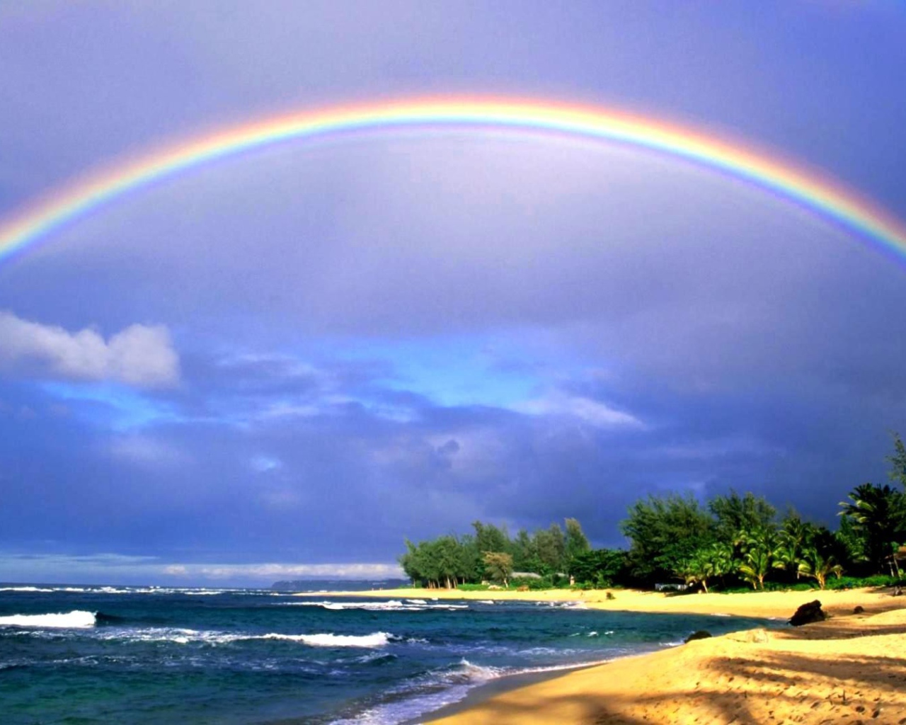 Rainbow over the sea and the beach