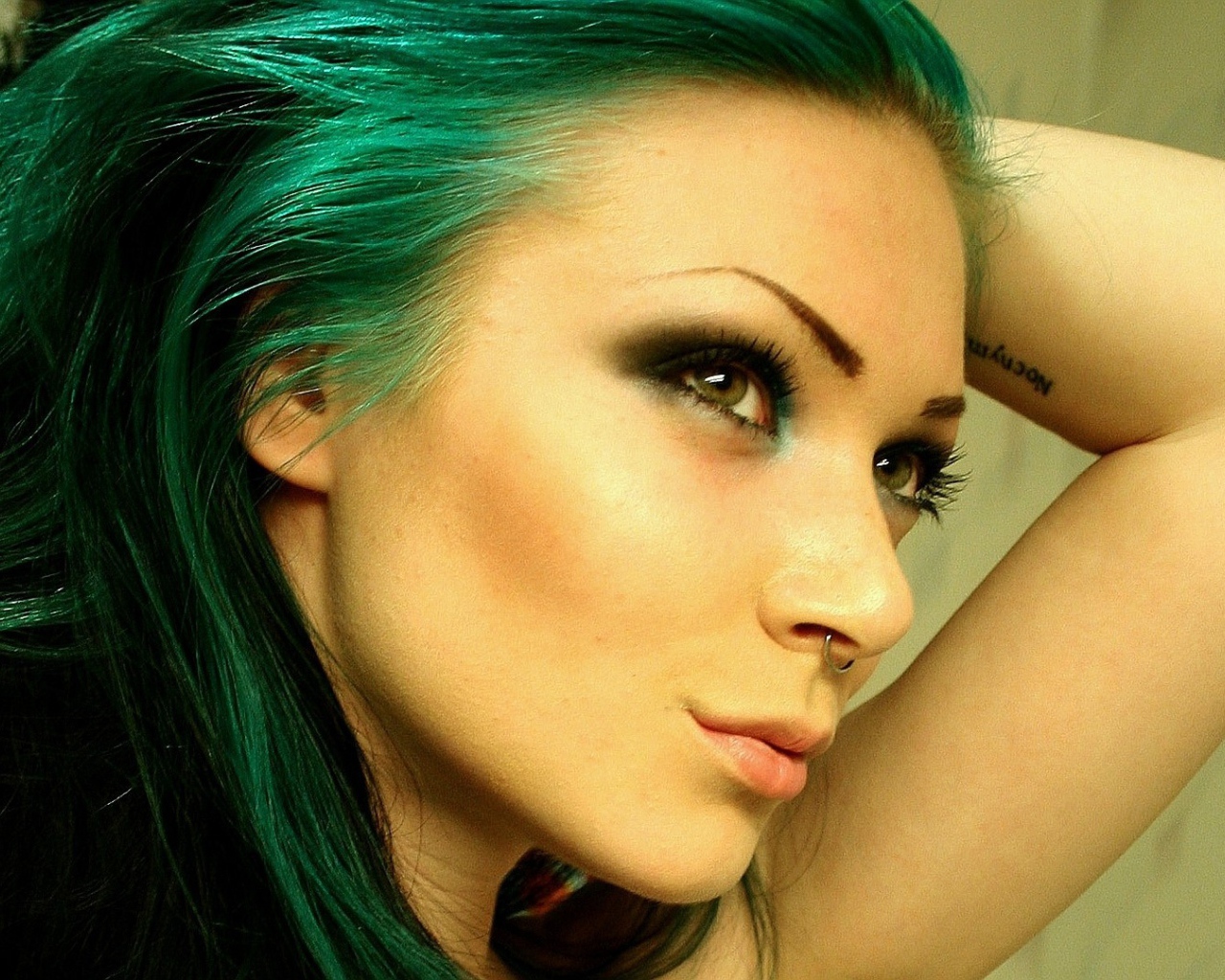 Девушка зеленоволосая с пирсингом в носу и татуировкой на руке