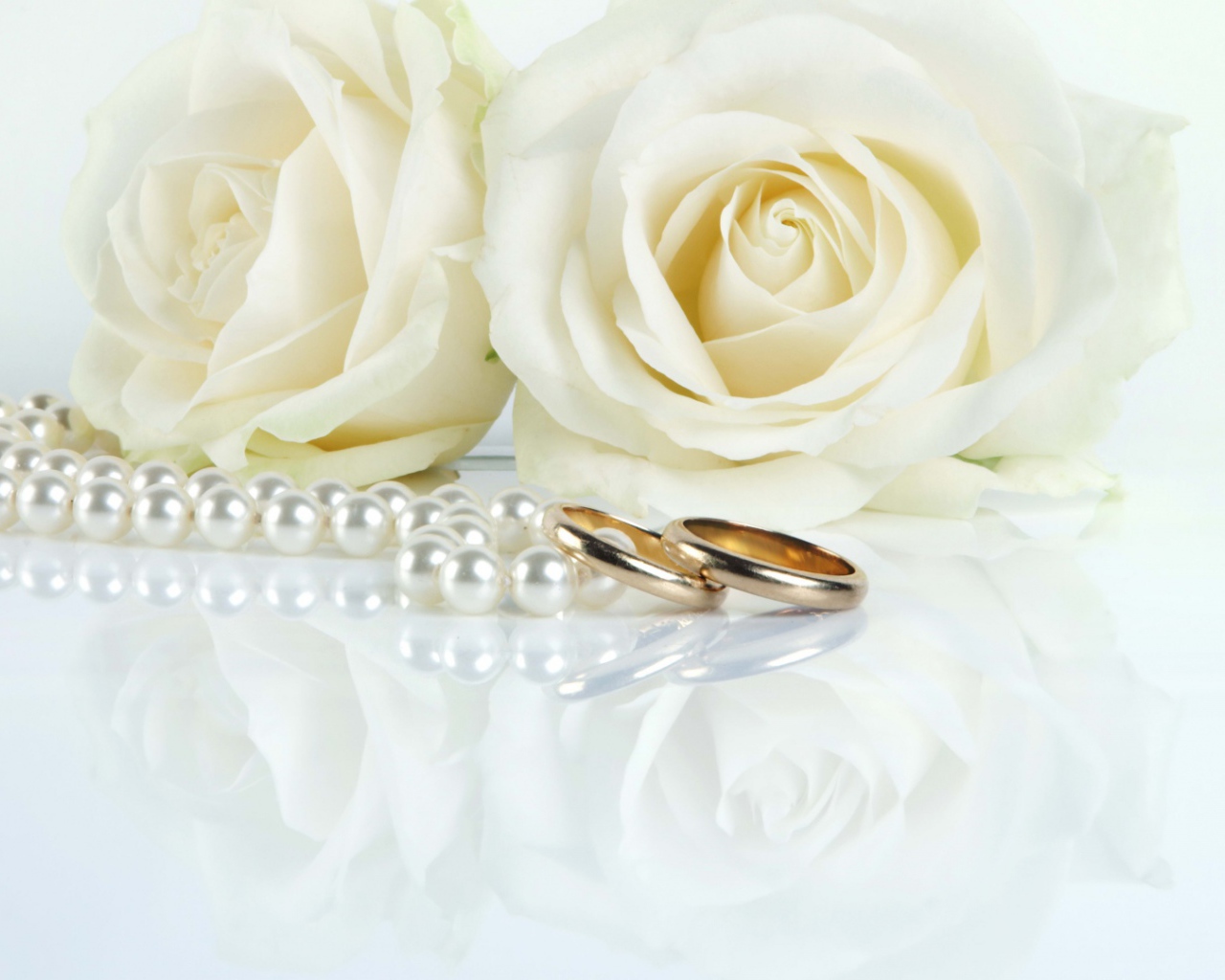 White roses and wedding rings