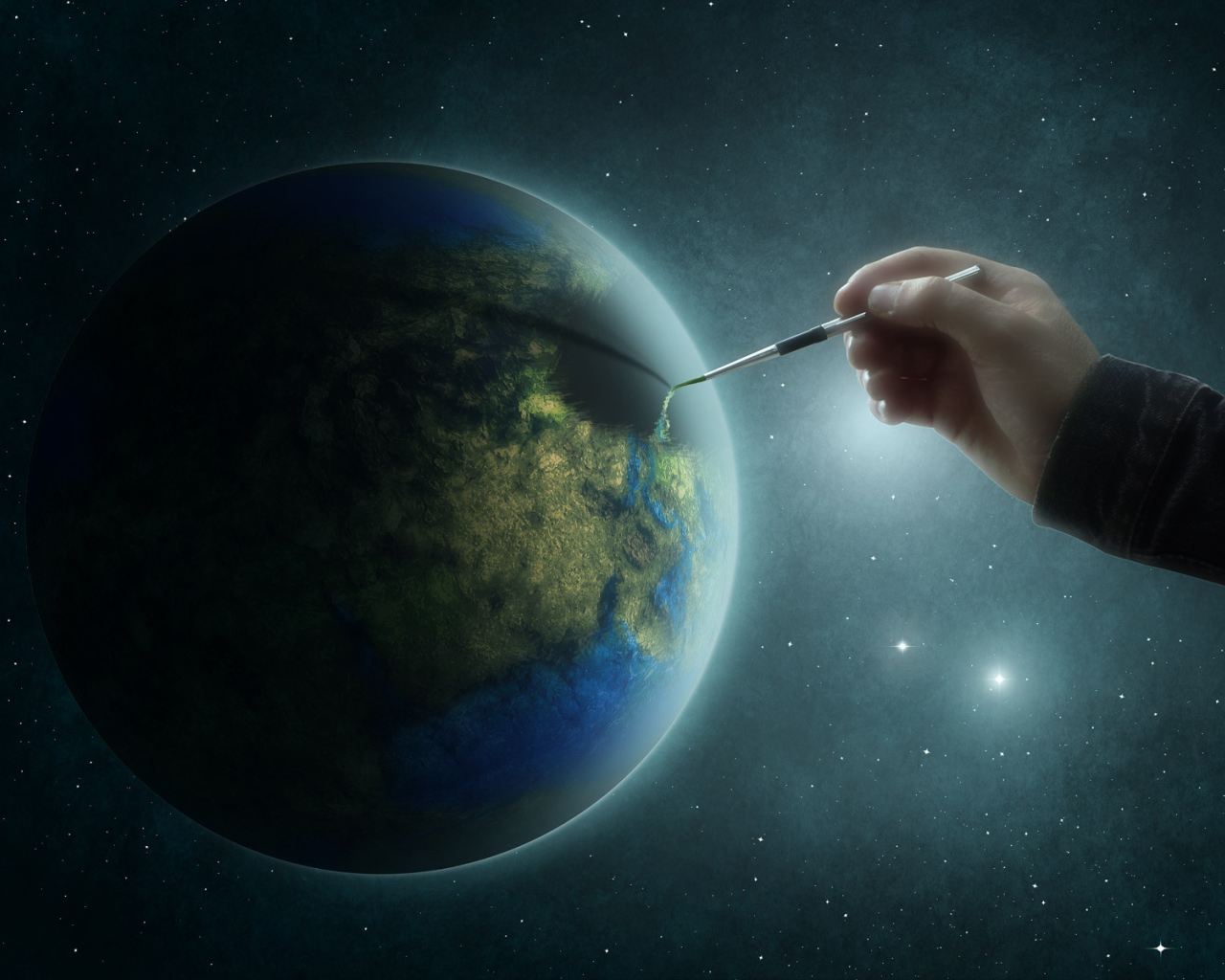 Рука рисует на планете