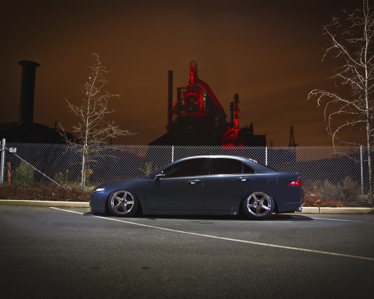 Черная Honda на фоне ночного завода