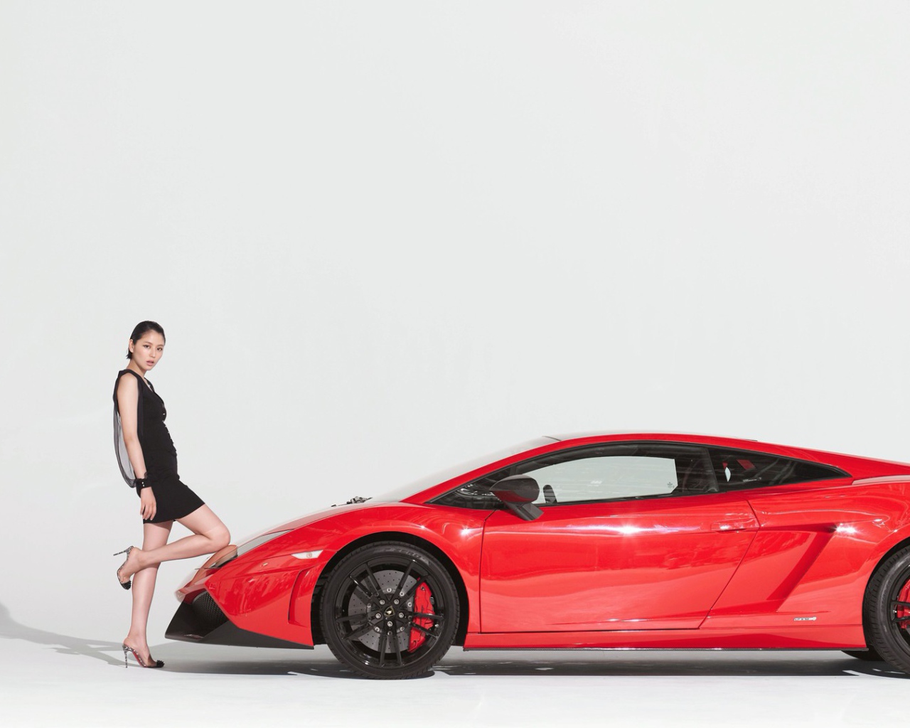 Девушка поставила колено на капот автомобиля