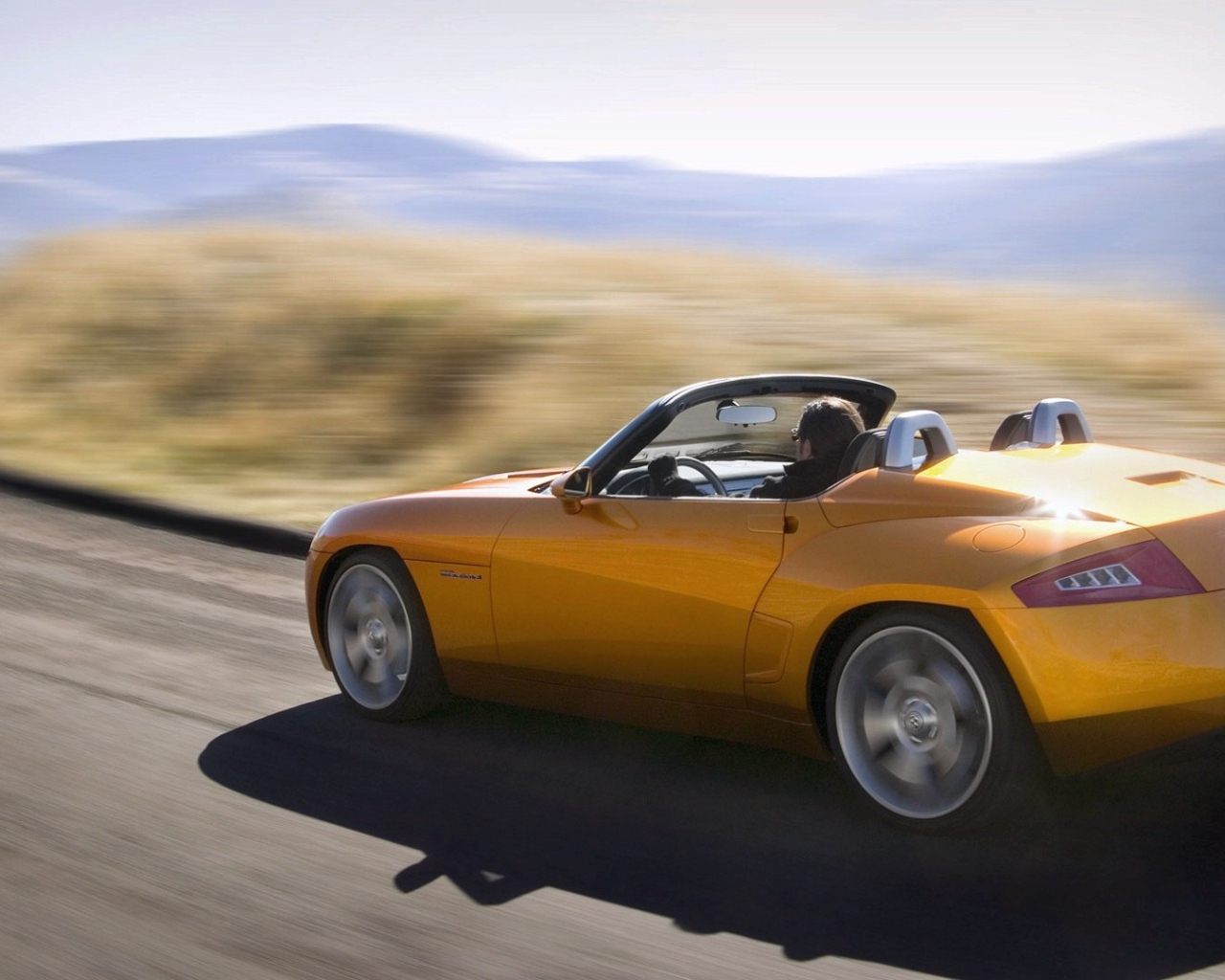 Желтый спортивный кабриолет на шоссе