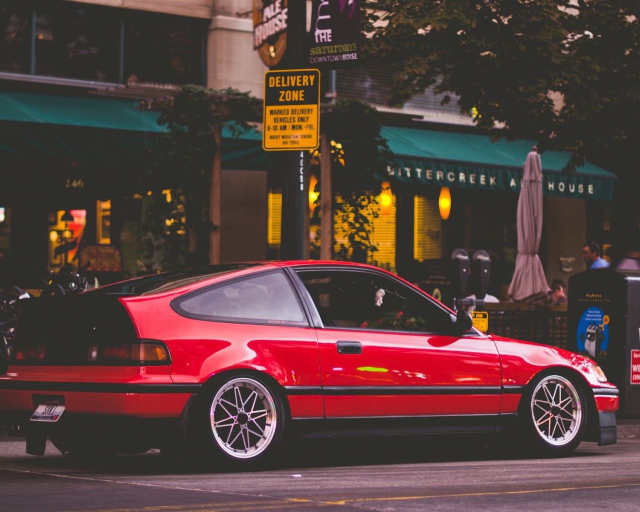 Red Honda CRX is standing at a street cafe