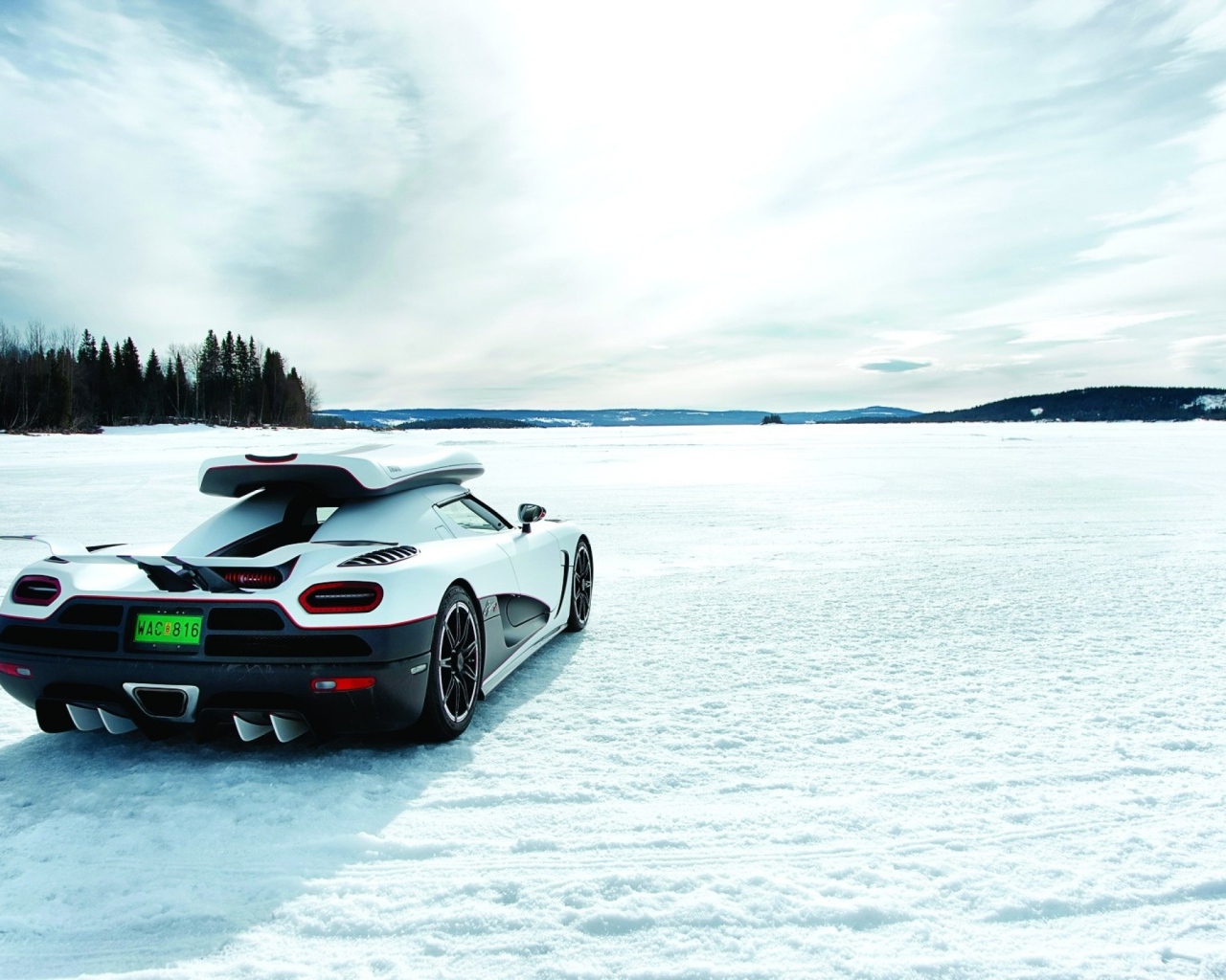White Koenigsegg on a snow-covered field