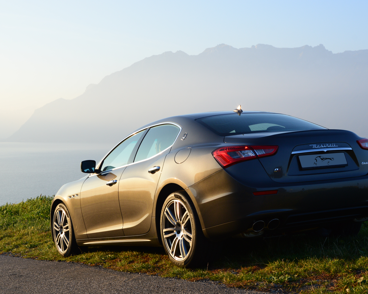 Коричневый Maserati на фоне гор