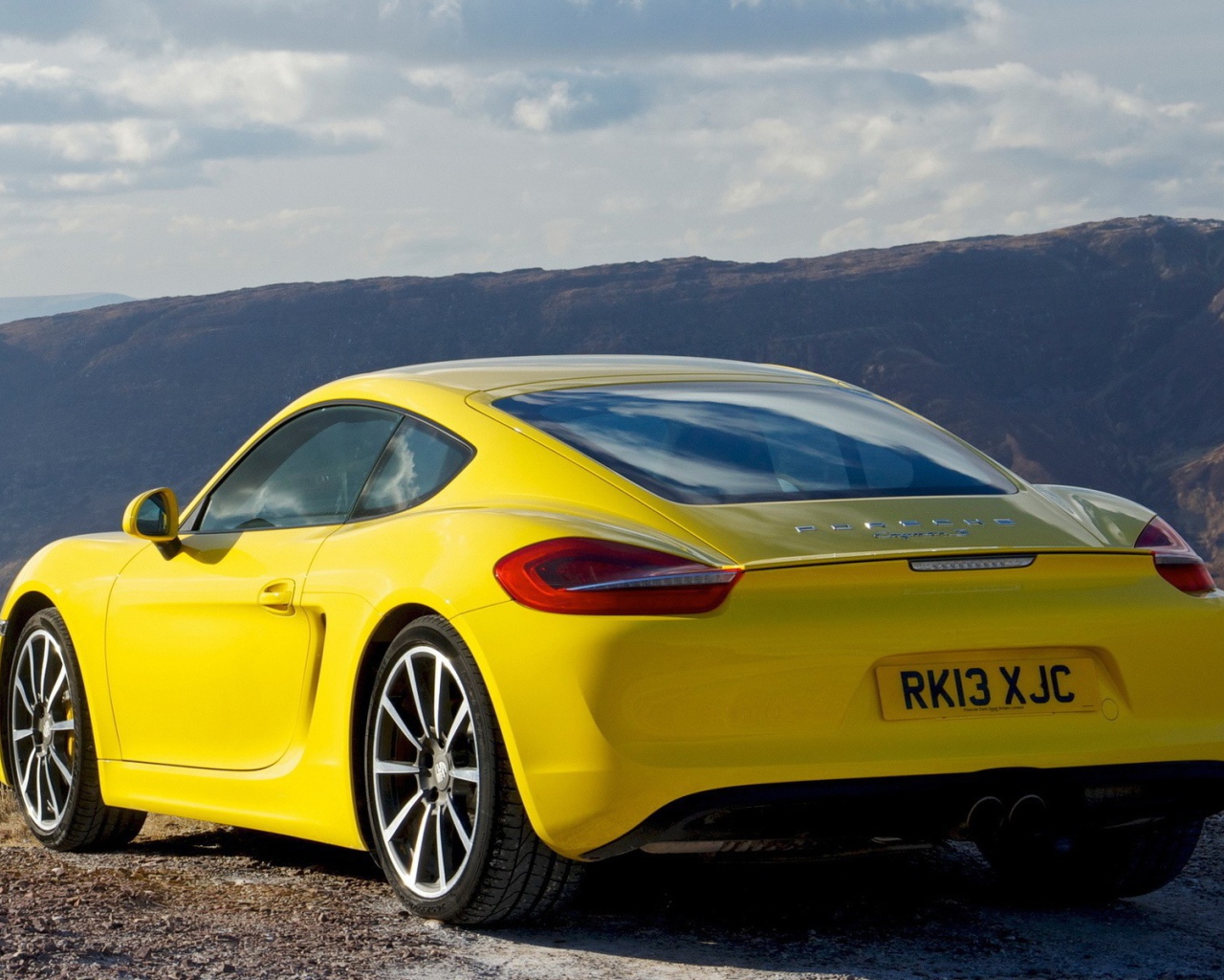 Красивый желтый Porsche в горах