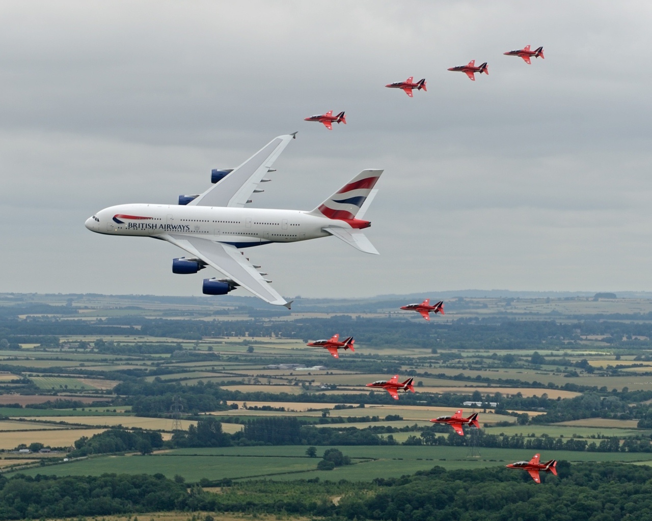 Airbus A380 в сопровождении красных истребителей
