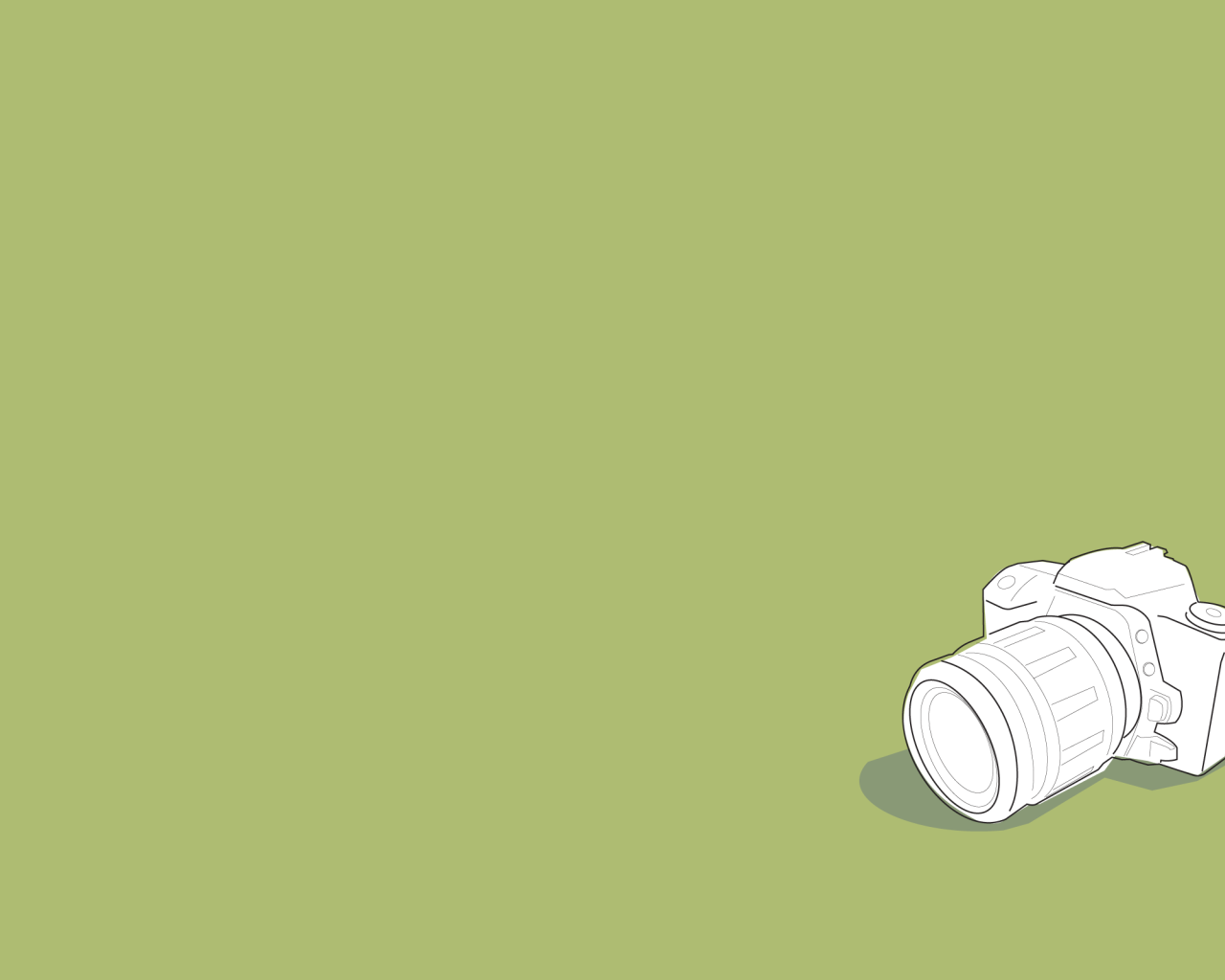 Белый фотоаппарат, зеленый фон