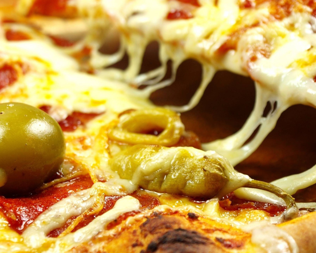 Pizza with cheese and green olives