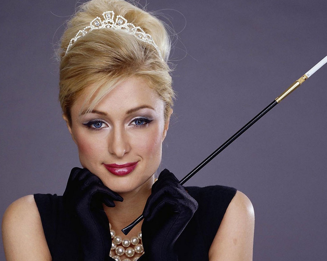 Девушка держит в руке дамский мундштук