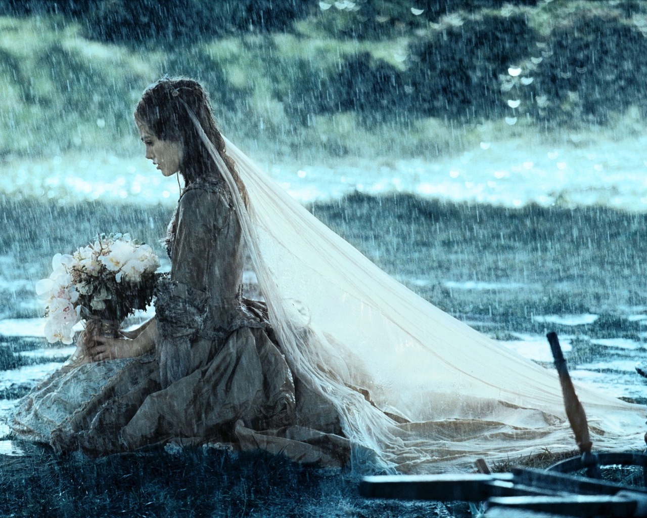 Невеста сидит на коленях под дождем