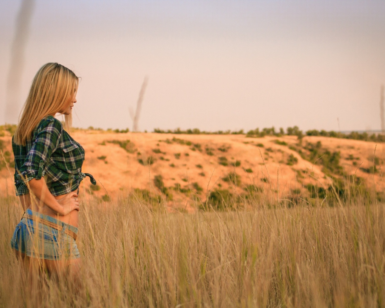 Girl in denim shorts walking in the field