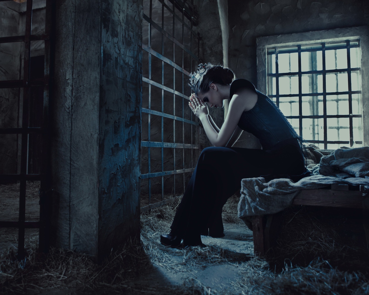 Девушка сидит за решеткой в тюрьме