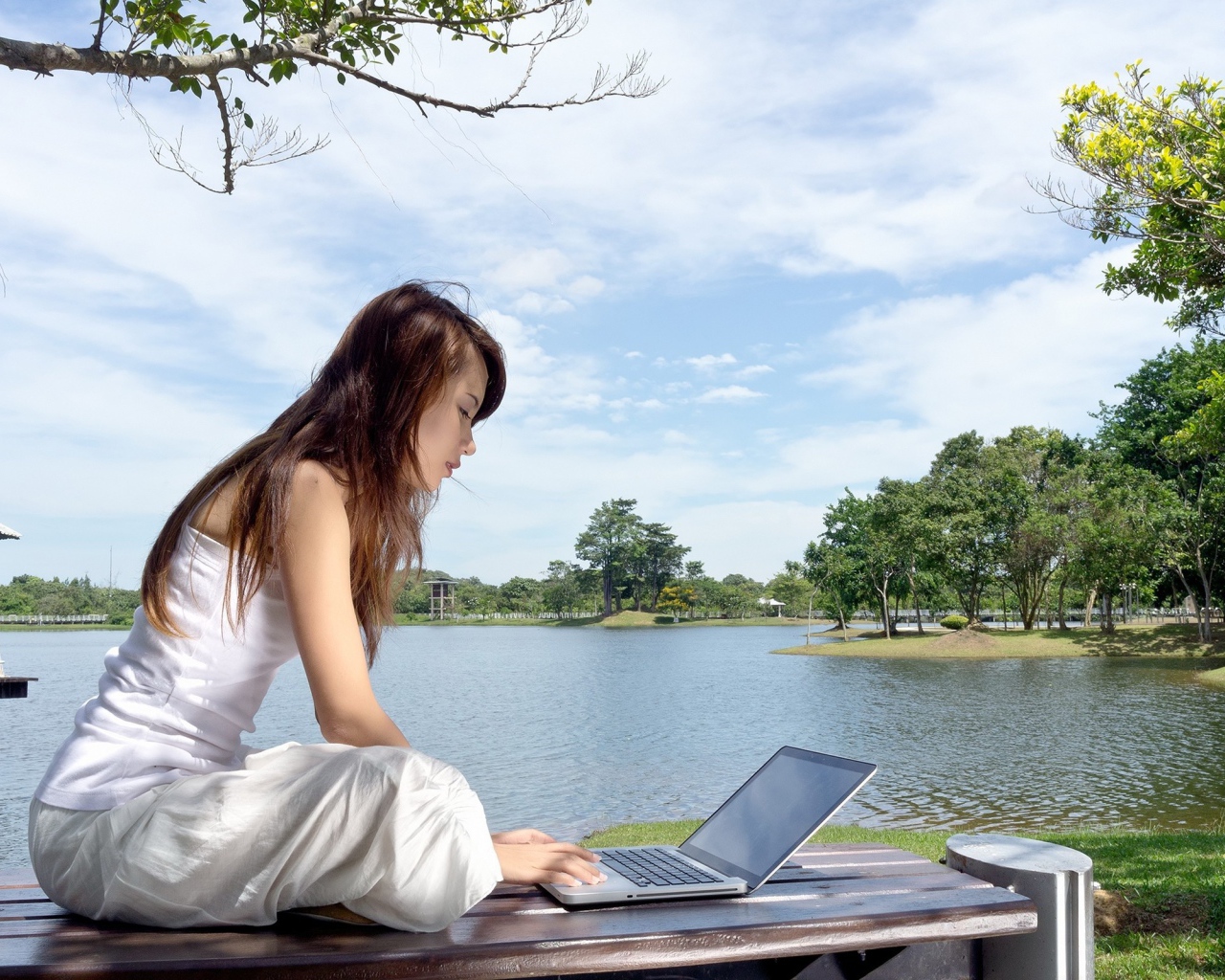 Девушка с ноутбуком у озера