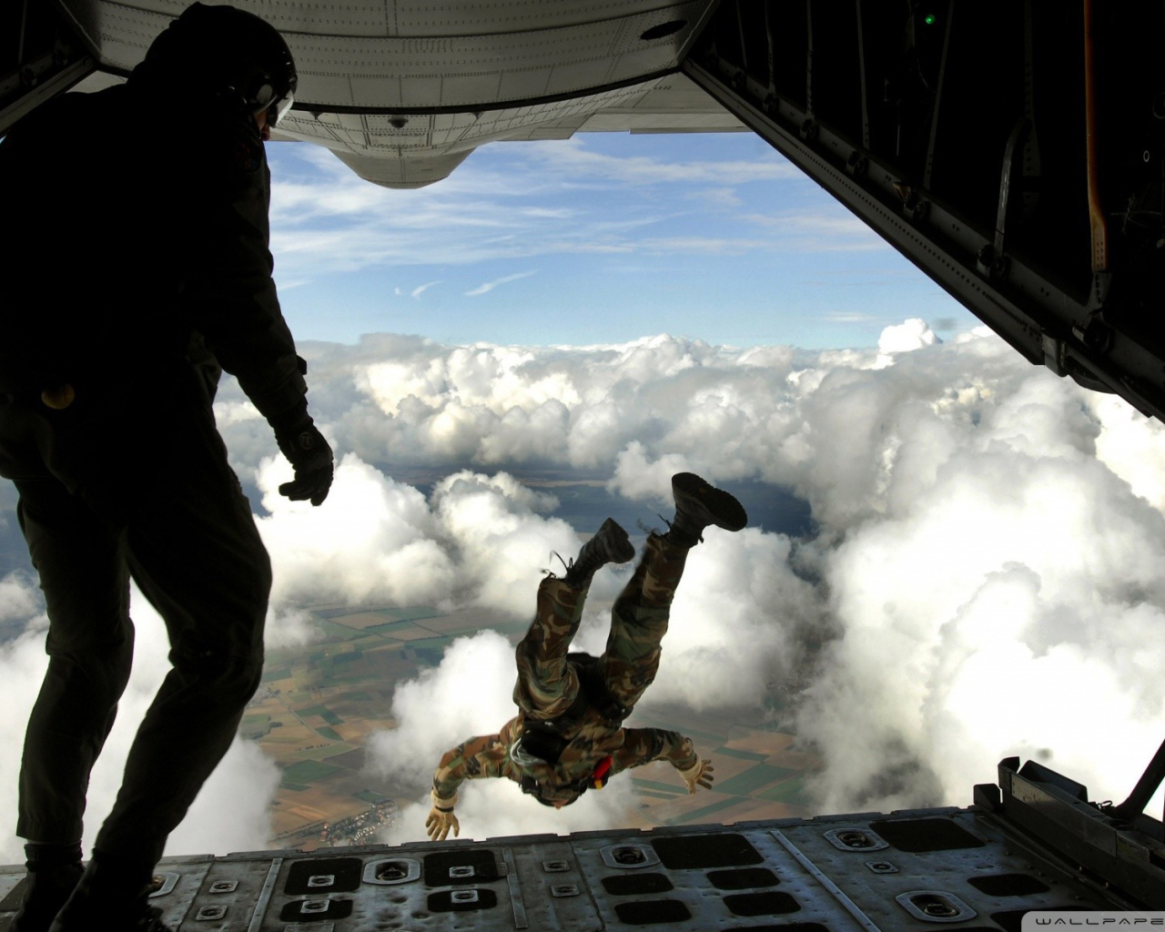 Paratroopers are jumping from an airplane