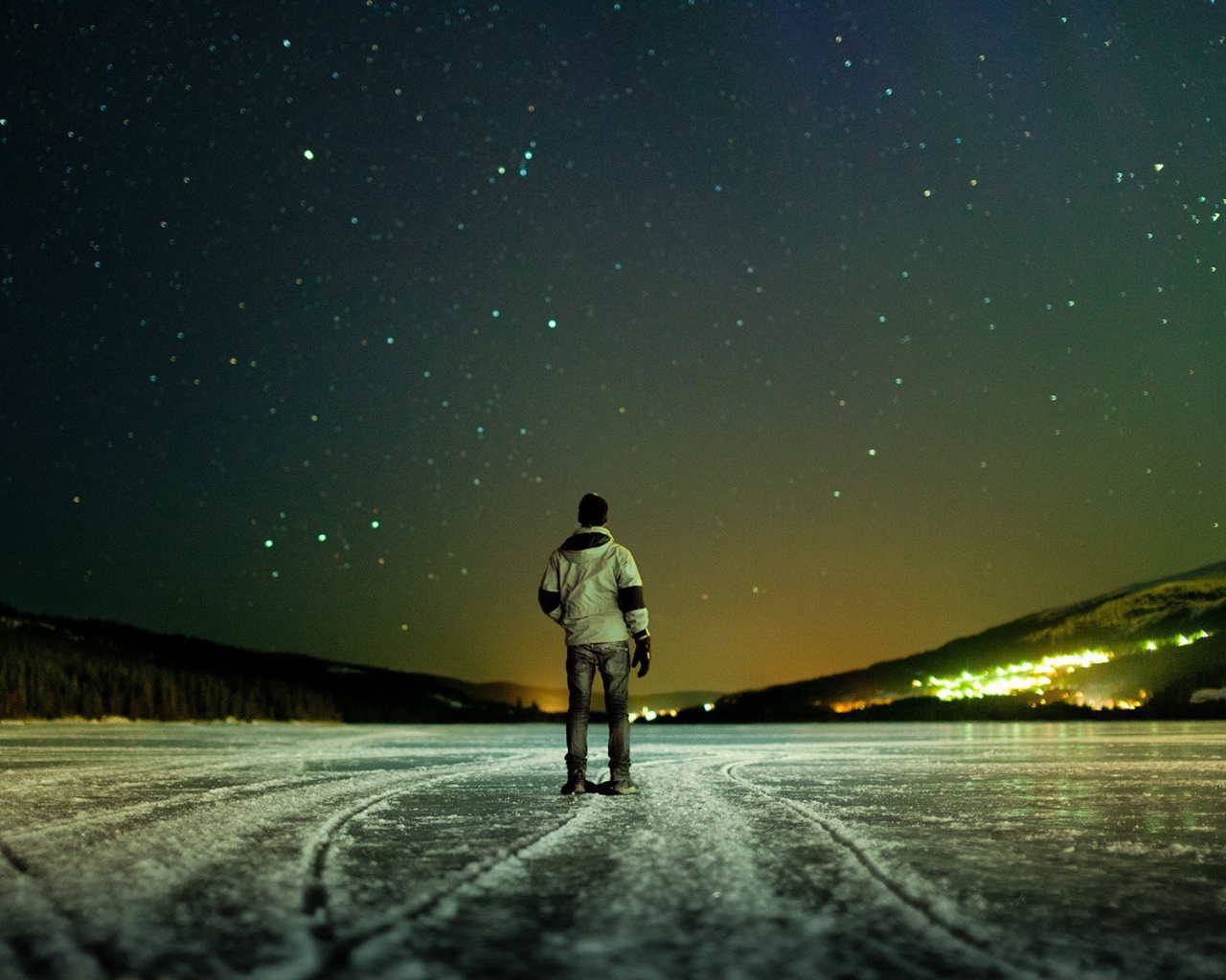 The man on the ice looking up at the stars