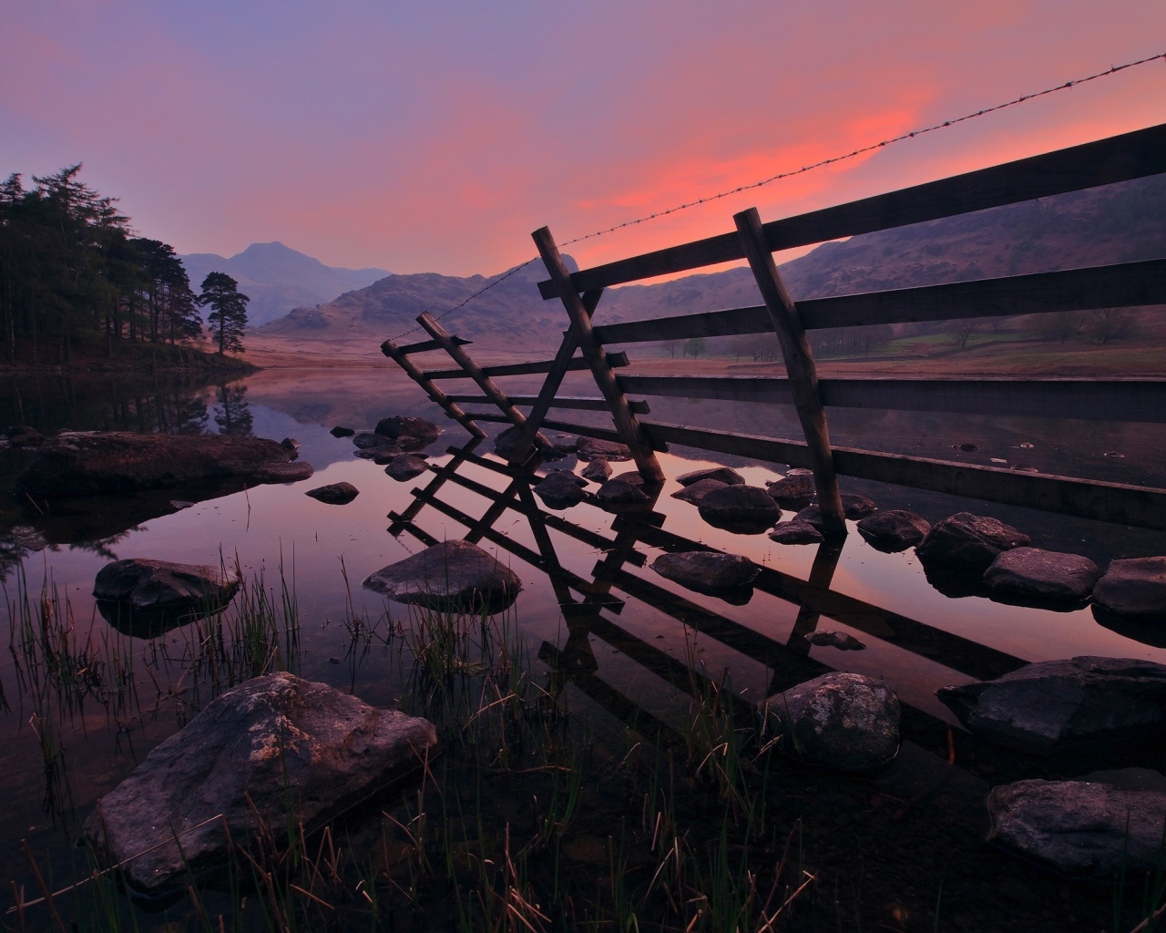 Полуразрушенный забор у воды