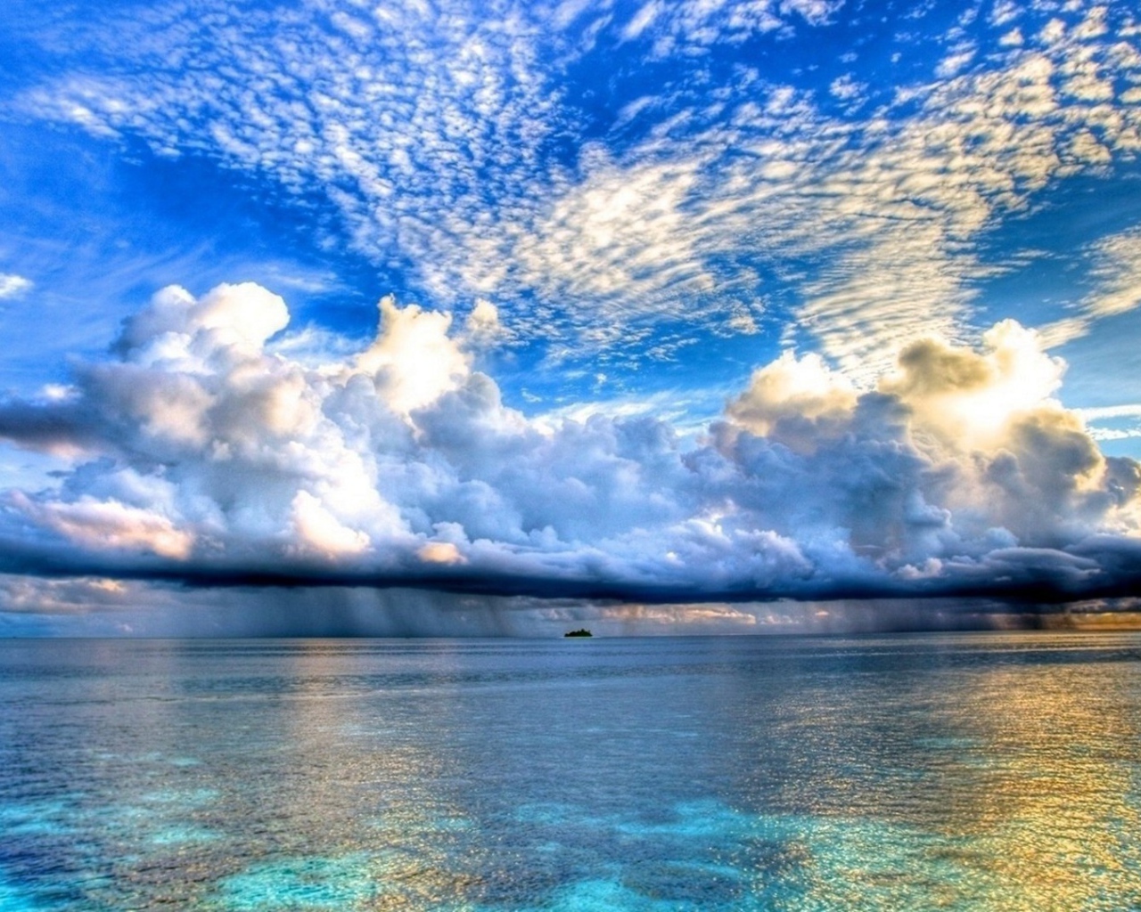 Разные облака над островком в океане