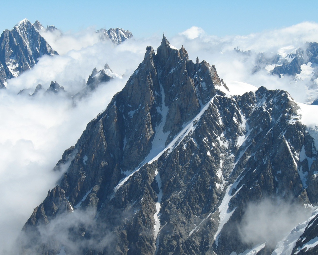 Острые вершины гор среди облаков