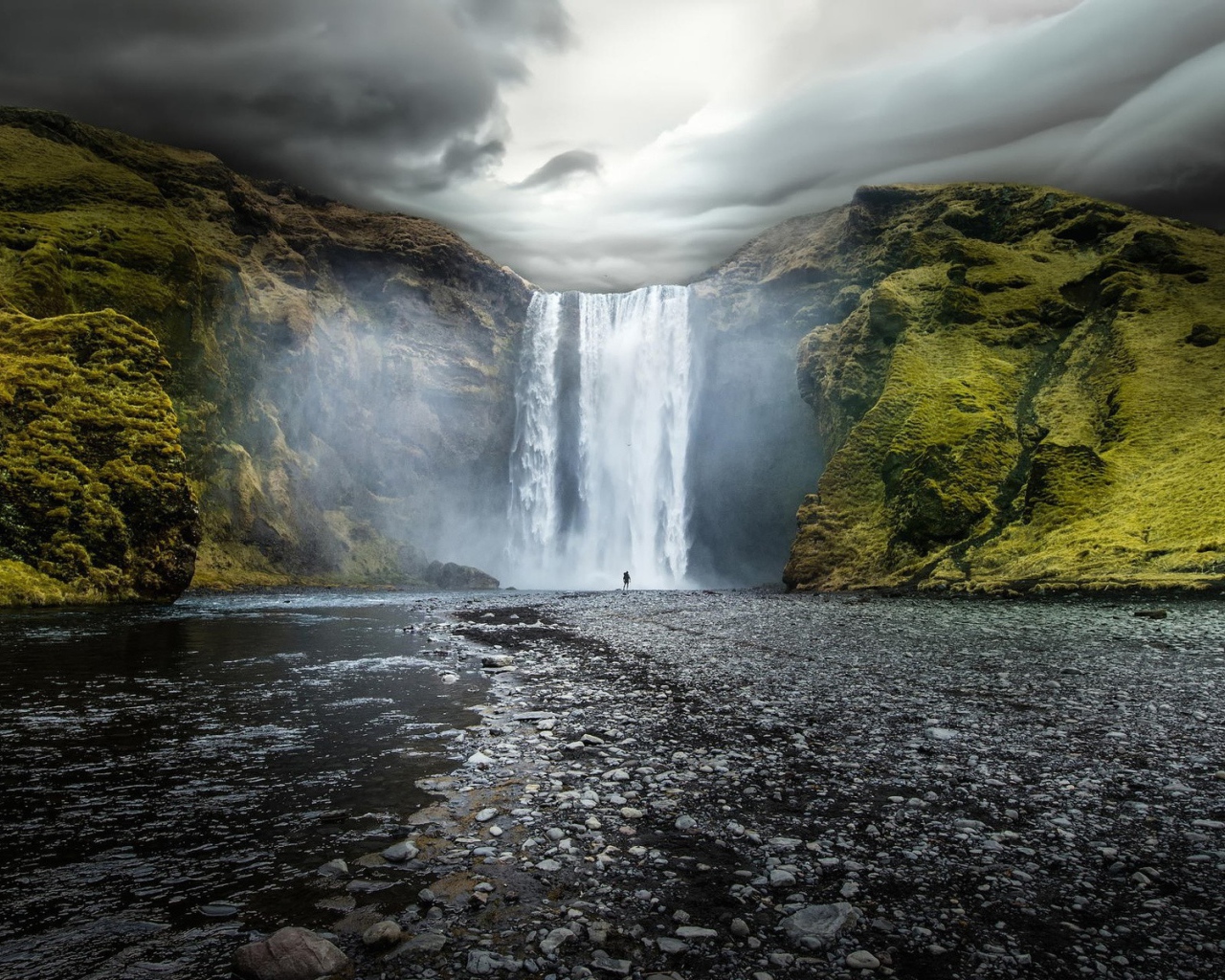 Водопад между зелеными скалами