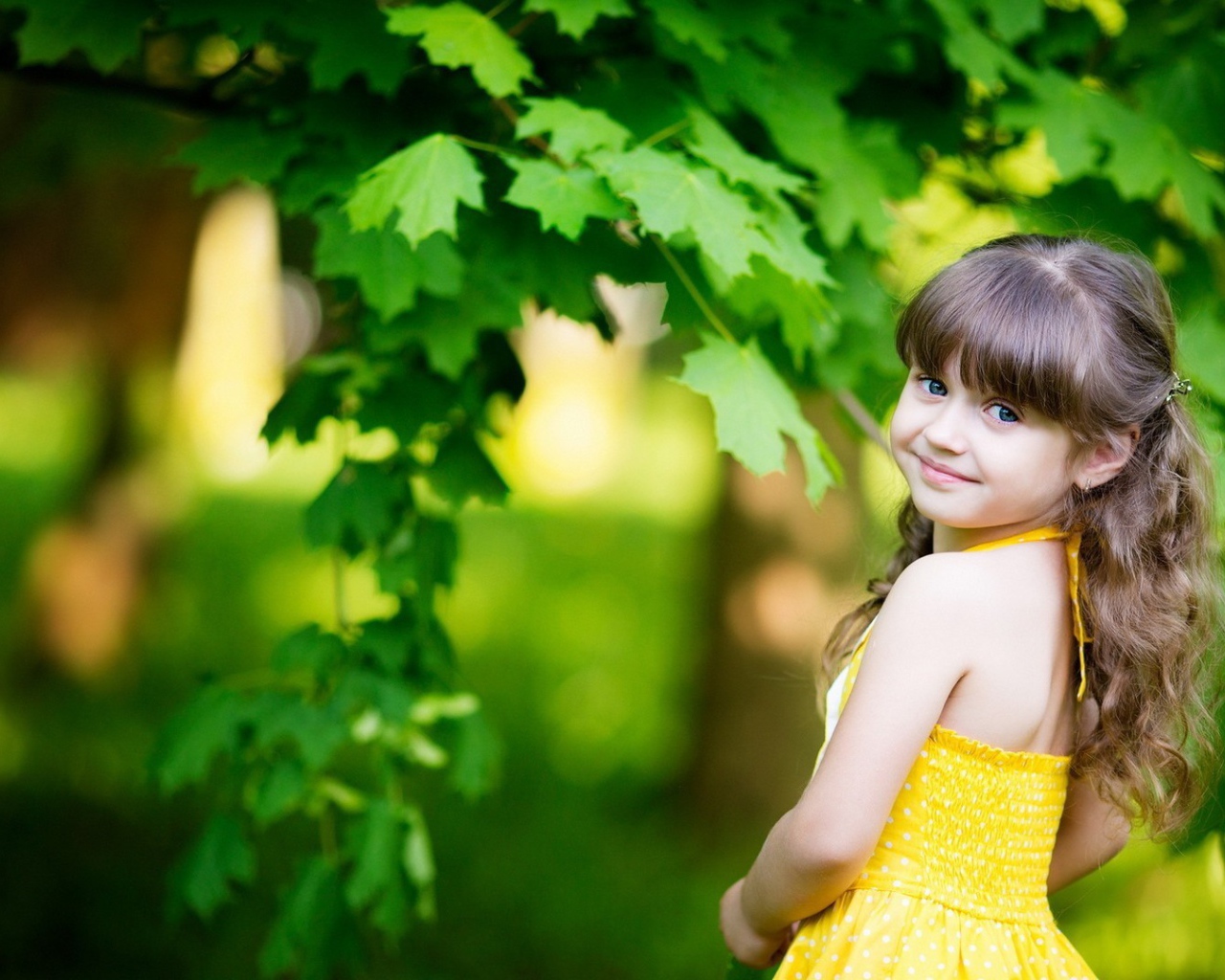 Маленькая девочка у зеленого клена