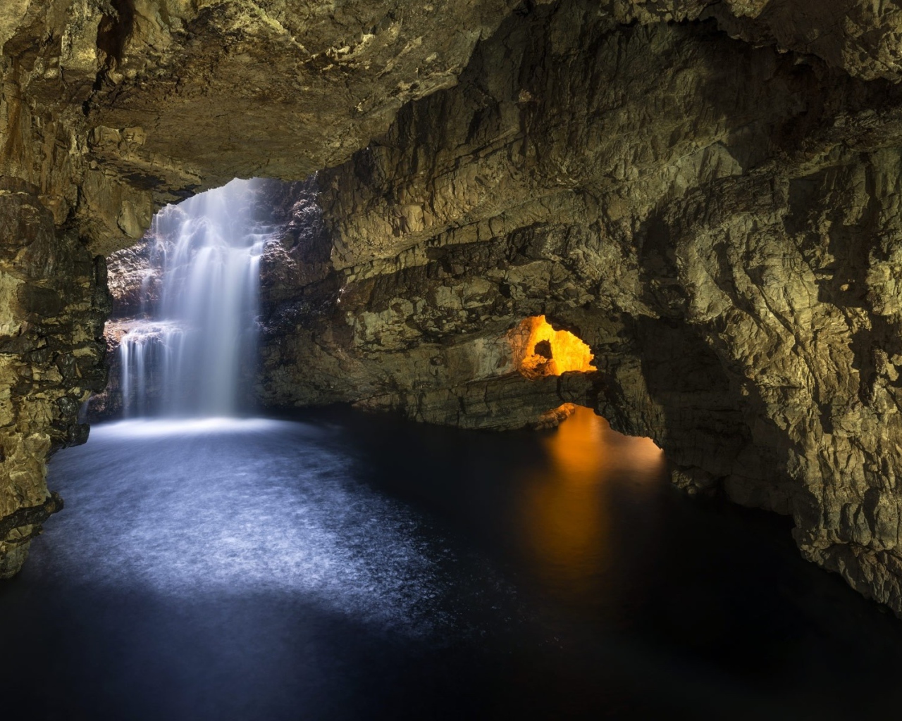 Waterfall in a stone cave in Scotland